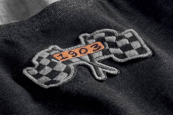 Closeup of the black and white checkered flag logo of the Harley-Davidson 1903 collection.