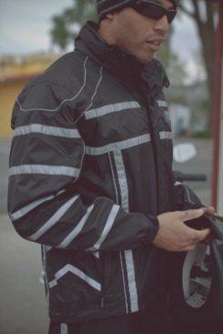 A man wearing motorcycle rain gear. The gear is an Illumination-360°-Rain-Suit from Harley-Davidson.